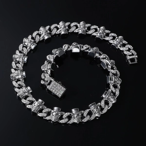 Macro detail of silver Cuban chain with diamond skull links and iced-out rectangle clasp