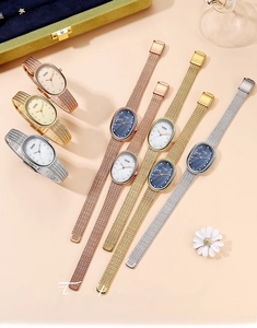 Detail of luxury oval women's watches with mother-of-pearl dials and metal mesh bands