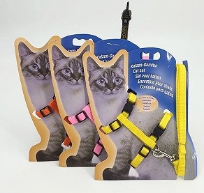 Close-up of adjustable nylon cat harnesses and leashes in vibrant orange, pink, and yellow