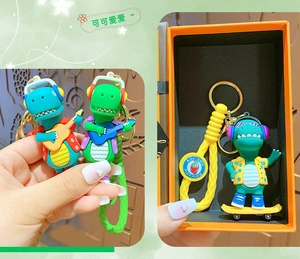 Detailed view of cute silicone dinosaur keychains with colorful guitars and gift box