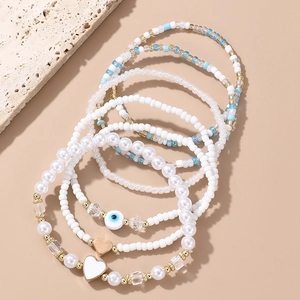 Set of 7 beaded bracelets with evil eye charm, seed beads and heart pendants