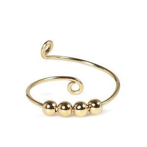 Adjustable golden spiral anxiety ring featuring four rotating metal beads on an open band