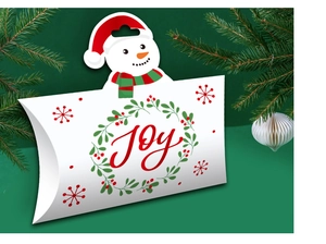 Detail of pillow-shaped Christmas candy box with snowman handle and Joy printed text