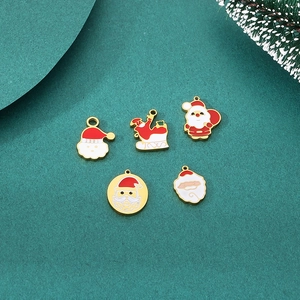 Macro view of 5-piece Christmas Santa enamel pendants with golden base for DIY jewelry