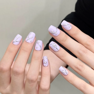 Matte lavender press-on nails with 3D silver lines and white pearl accents