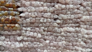 Bulk packs of heart-shaped rose quartz and agate stones in transparent poly bags