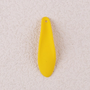 Macro detail of a bright yellow drop-shaped acrylic petal earring accessory with hole