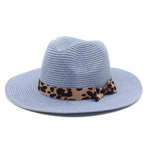 Close-up of light blue straw fedora hat featuring high-density weave and leopard print ribbon
