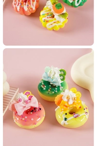 Detailed view of colorful miniature donuts with fruit slices, cream, and silk ribbons
