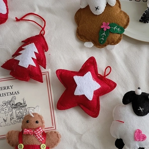 Flat lay of handmade felt Christmas ornaments with star and gingerbread man decorations