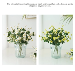 Detailed view of small faux roses in light yellow and white within a blue glass vase
