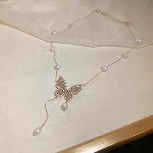 Butterfly pearl tassel necklace with gold plating and zircon inlay on a beige background