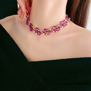 Close-up of vintage flower necklace in rose gold with purple stones and clear zircons