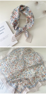 Detail of floral linen square scarf showing knot tie style and flat layout print