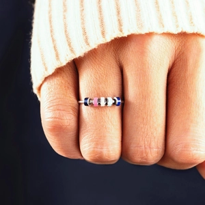 Fidget spinner ring with five colorful enamel beads on a thin stainless steel band