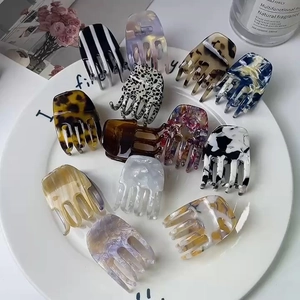 Detailed collection of assorted acetate hair claws with marble and tortoiseshell patterns