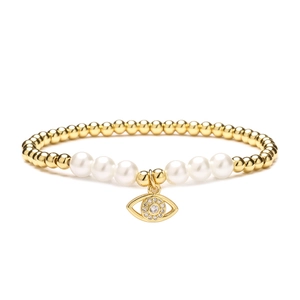 Golden beaded bracelet with white pearls and a sparkling Evil Eye charm on white background
