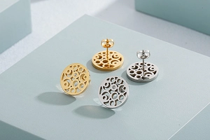 Detailed view of hollow geometric round stud earrings in gold and silver with zircon