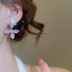 Close-up of pink crystal flower drop earrings with silver settings and stud details