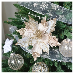 Close-up of champagne gold glitter poinsettia flower on a decorated Christmas tree