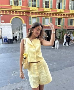 Detailed texture of yellow cotton-linen sleeveless vest set and matching shorts