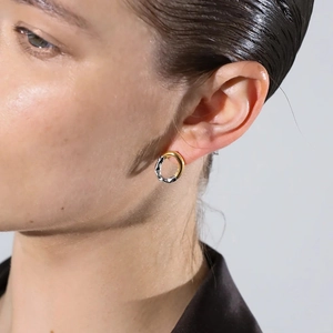 Minimalist 18K gold and silver two-tone irregular round earrings worn by a model