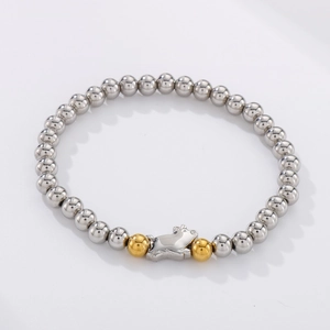 Close-up of stainless steel beaded bracelet with pig charm and golden accents