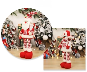 Detail view of knitted Christmas gnome ornaments featuring festive red and white patterns