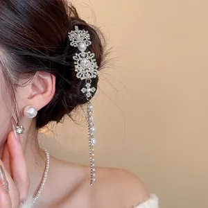 Silver vintage style hair clip with tassels pearls and crystals shown on model