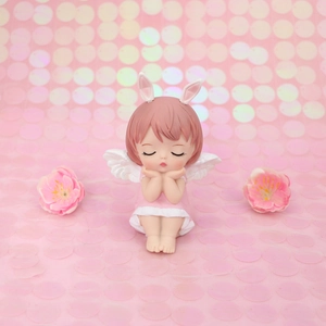 Macro detail of cute pink angel girl figurine with bunny ears for cake decoration