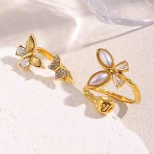 Detail of 18K gold-plated open rings with butterfly motifs and sparkling zircon inlay
