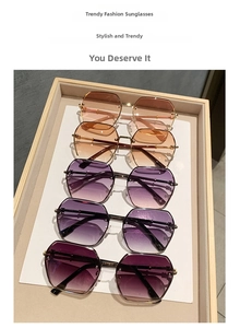 Close-up of rimless gradient lens sunglasses in various colors on a display tray