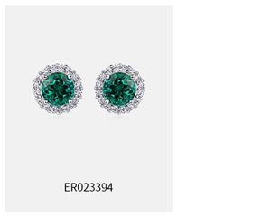 Detail view of round emerald halo stud earrings with micro-pave white side stones
