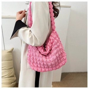 Detail of pink bubble textured shoulder bag with lightweight fabric and ruched design
