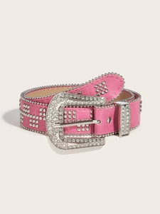 Close-up of pink faux crocodile belt with sparkly rhinestone buckle and metal studs