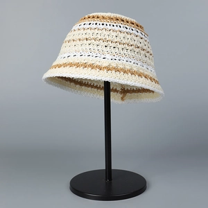 Close-up of hollowed-out striped knit bucket hat with breathable crochet texture