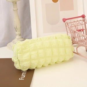 Detail shot of the light green 3D bubble texture and sturdy zipper on the soft pencil case