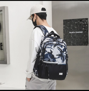 Close-up of camouflage backpack with durable fabric and explore the future slogan