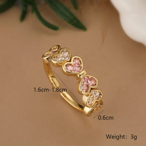 Detail shot of a 18K gold plated heart ring featuring pink and white zircon stones