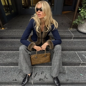 Detail shot of navy slim jacket featuring brown faux fur collar and matching sleeve cuffs