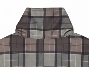 Detail view of the checkered coat neckline with precise stitching and grey plaid pattern