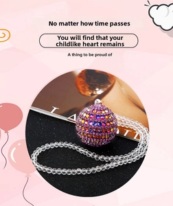 Macro shot of colorful gradient crystal sphere car pendant with clear beaded chain