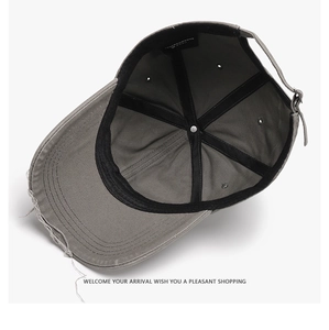 Macro view of gray washed cotton baseball cap showing internal seams and adjustable strap