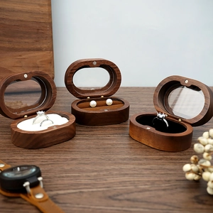 Elegant walnut wood oval jewelry box with plush velvet lining for rings and earrings