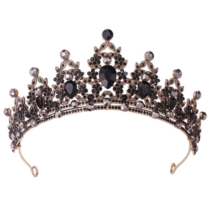 Detailed view of luxury bridal crown with black crystals and vintage gold leaf design