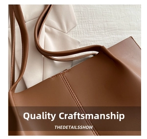 Close-up of high-quality stitching and matte leather texture on brown tote bag