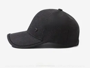 Detailed side view of dark grey textured baseball cap with metallic shield logo