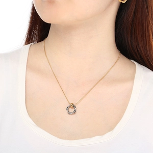 Detail of interlocking gold and silver circle pendant on sleek titanium snake chain necklace