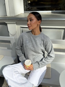 Women's minimalist grey crewneck sweater featuring stylish side slits in a knit finish