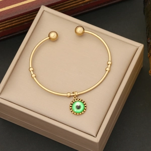 Bracciale rigido aperto in acciaio inossidabile dorato con ciondolo occhio greco verde